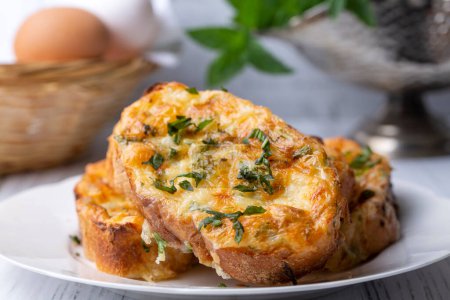 Photo for Turkish Egg Breads. It is called "Yumurtali Ekmek" in Turkish. French Toast. Turkish and Arabic Traditional Breakfast Baked or Fried Egg Bread. Egg bread with cheese and parsley. - Royalty Free Image