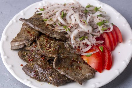 Photo for Traditional Turkish Liver kebab cuisine. Leaf Liver spicy. Delicious turkish ciger. (Turkish name; yaprak ciger) - Royalty Free Image