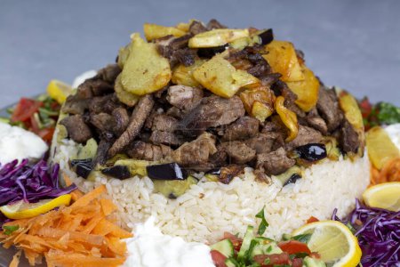 Photo for Middle Eastern food culture, Turkish cuisine; type of pilaf, pilaf with meat and vegetables, Turkish name; Maklube - Royalty Free Image