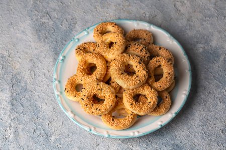 Photo for Turkish Bagel with sesame seeds or salty ring cookies. Turkish name; Kandil simidi or tuzlu halka kurabiye - Royalty Free Image