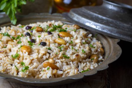 Photo for Traditional delicious Turkish food; rice pilaf with pine nuts and currants (Turkish name; bademli ic pilav or pilaf) - Royalty Free Image