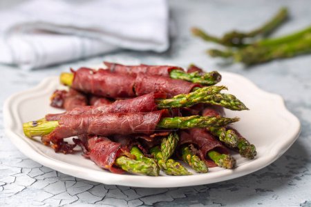 Photo for Grilled asparagus with bacon (Turkish name; Pastirmali kuskonmaz izgara) - Royalty Free Image