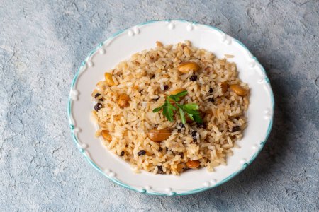 Photo for Traditional delicious Turkish food; rice pilaf with pine nuts and currants (Turkish name; bademli ic pilav or pilaf) - Royalty Free Image
