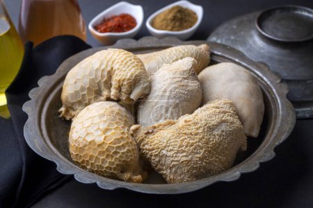 Photo for Traditional middle eastern food; stuffed offal, stuffed tripe. Stuffed belly mumbar. Turkish name; karin mumbar dolmasi - Royalty Free Image