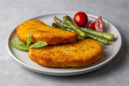 Photo for Cordon bleu served with asparagus. - Royalty Free Image