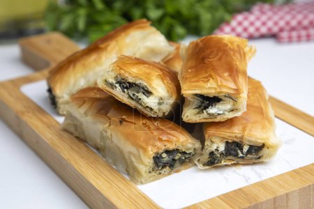 Photo for Handmade Spinach Cheese Pie - pastry, Turkish name; el acmasi borek, rulo borek. Turkish borek rolls with spinach and cheese. A traditional Turkish pastry rulo borek - Royalty Free Image