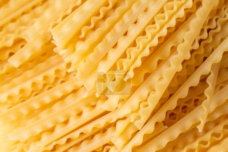 Photo for Mafaldine, also known as reginette (Italian for little queens) or simply mafalda or mafalde, is a type of ribbon-shaped pasta. - Royalty Free Image