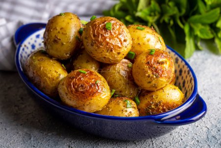 Photo for Roasted baked baby potatoes with garlic and herbs. - Royalty Free Image