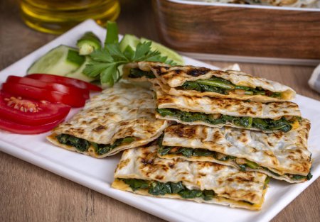 Traditional Turkish food, Turkish pancake gozleme with cheese and herb. The appetizer is Turkish pastry. There are varieties such as cheese, spinach, potato.