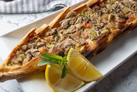 Photo for Traditional delicious Turkish food, meat pide (Turkish name; Kusbasi etli pide) - Royalty Free Image