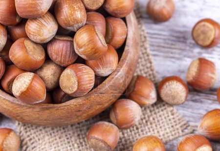 Photo for Shelled Hazelnuts is important for health on the wooden background - Royalty Free Image