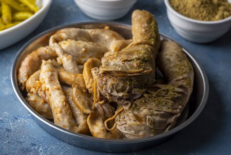 Photo for Traditional Turkish Stuffed rice tripe or offal food on the table in Turkish Restaurant. Shirdan Dolma is the favorite food Adana city of Turkey. (Turkish name; Sirdan) - Royalty Free Image