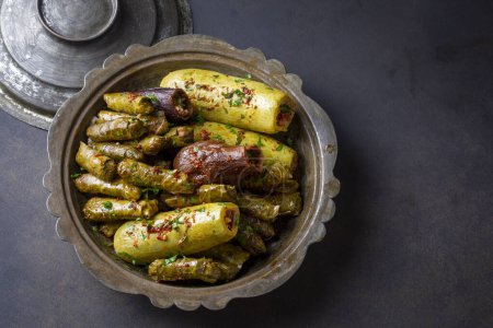 Photo for Traditional Turkish cuisine; Mixed Stuffed Vegetables. Stuffed leaves, stuffed zucchini and stuffed eggplant. Turkish name; Yaprak sarmasi, kabak dolmasi - Royalty Free Image
