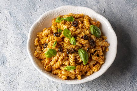 Photo for Basil leaves on pasta with arabiata sauce - Royalty Free Image
