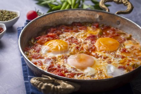 Photo for Famous Turkish menemen dinner on table, made by eggs, pepper and tomatoes. - Royalty Free Image