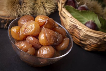 Photo for Chestnut dessert and chestnuts on a plate. Traditional delicious Turkish dessert; chestnut candies (Kestane Sekeri) - Royalty Free Image
