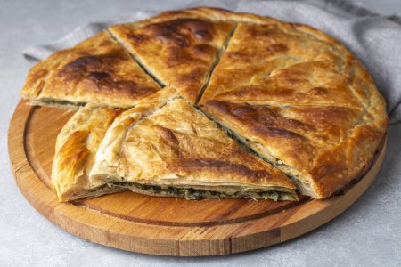 Photo for Spanakopita, greek phyllo pastry pie with spinach and feta cheese filling. Delicious handmade pies. Turkish name; el acmasi borek - Royalty Free Image
