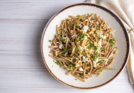 Photo for Turkish Noodle - Eriste with cheese, walnuts and parsley. - Royalty Free Image
