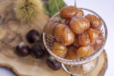 Photo for Chestnut dessert and chestnuts on a plate. Traditional delicious Turkish dessert; chestnut candies (Kestane Sekeri) - Royalty Free Image