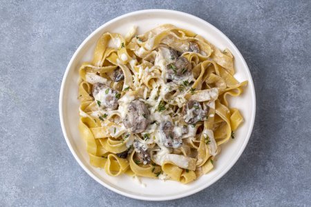 Photo for Homemade Italian fettuccine pasta (Fettuccine al Funghi Porcini) with mushroom and cream sauce. Traditional Italian cuisine. - Royalty Free Image