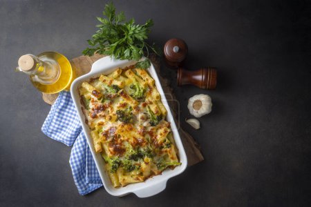 Photo for Pasta baked with broccoli and chicken. Broccoli, cheese and gratin sauce on baked penne pasta. - Royalty Free Image