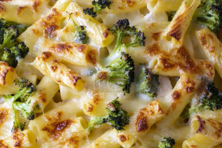 Photo for Pasta baked with broccoli and chicken. Broccoli, cheese and gratin sauce on baked penne pasta. - Royalty Free Image