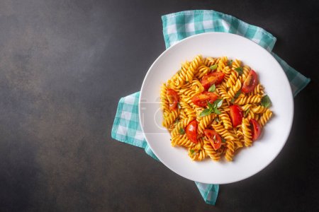 Photo for Fusilli pasta, spiral or spirali pasta with tomato sauce - Italian food style (Turkish name; domatesli, domates soslu burgu makarna) - Royalty Free Image