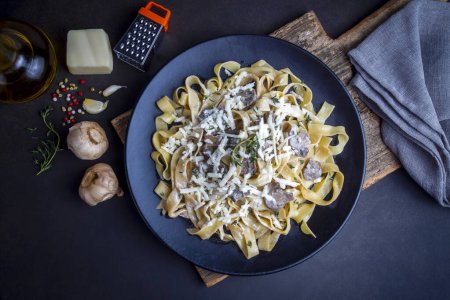 Photo for Homemade Italian fettuccine pasta (Fettuccine al Funghi Porcini) with mushroom and cream sauce. Traditional Italian cuisine. - Royalty Free Image