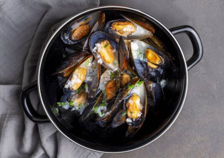 Photo for Delicious seafood mussels with parsley sauce and lemon. Delicious steamed mussels. - Royalty Free Image