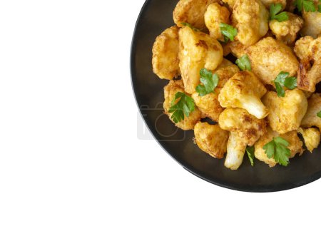 Photo for Fried in batter Cauliflower florets served on a black plate on a grey concrete table with ingredients, view from above, close-up, flatlay, copy space (Turkish name; karnabahar kizartmasi) - Royalty Free Image