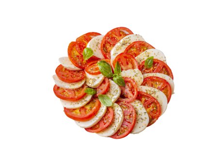 Foto de Ensalada caprese italiana con tomates en rodajas, mozzarella, albahaca, aceite de oliva - Imagen libre de derechos