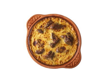 Photo for Tave kosi is a national Albanian dish of baked lamb and rice with yoghurt close-up in a pan on the table. horizontal top view from above. Turkish name; Elbasan tava - Royalty Free Image