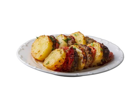 Foto de Traditional Turkish food; baked potatoes and meatballs. Turkish name; kofteli patates dizmesi, patates dizme - Imagen libre de derechos