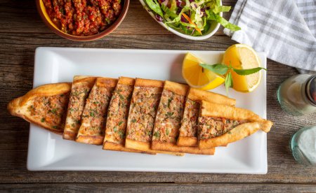 Photo for Turkish pide with minced meat, Turkish name; Kiymali Pide. Traditional Turkish cuisine. Turkish pizza Pita with meat. - Royalty Free Image