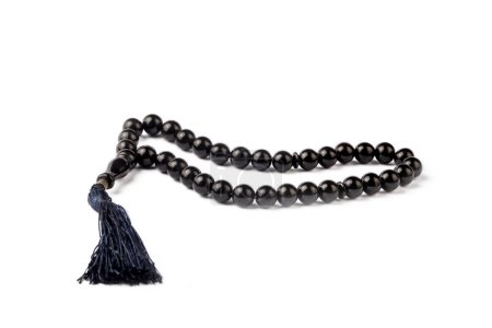 Photo for Black prayer beads with 33 knots made of stone on a matte surface on a white background (Turkish name; Tespih) - Royalty Free Image
