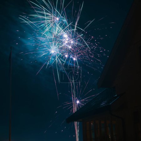 Foto de New year eve fireworks above the houses. - Imagen libre de derechos