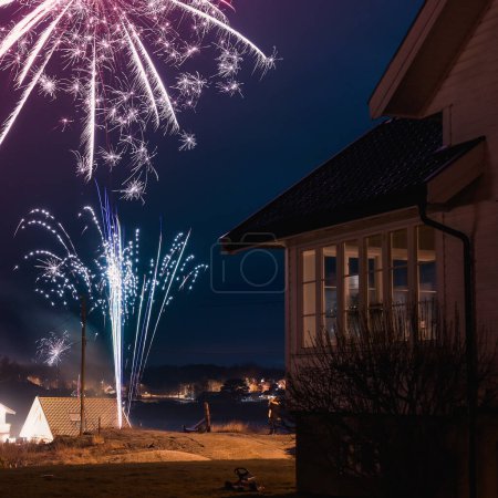 Photo for New year eve fireworks above the houses. - Royalty Free Image