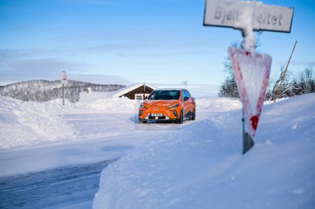 Foto de Rauland, Norway - January 14, 2023: Orange electric car MG4 is a hatchback chinese electric car - Imagen libre de derechos