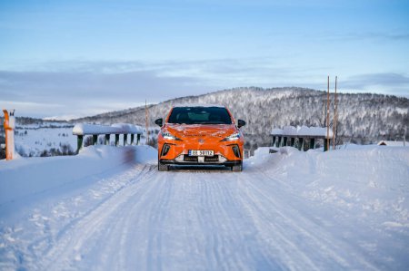 Photo for Rauland, Norway - January 14, 2023: Orange electric car MG4 is a hatchback chinese electric car - Royalty Free Image