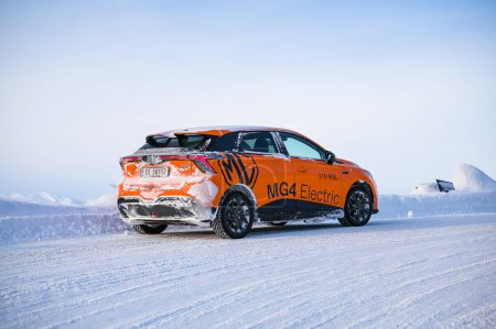 Foto de Rauland, Norway - January 14, 2023: Orange electric car MG4 is a hatchback chinese electric car - Imagen libre de derechos