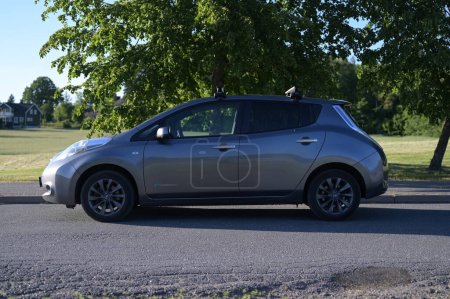 Photo for Tonsberg, Norway - June 2, 2023: silver gray NISSAN LEAF is a compact C-segment electric car . New car on a sunny summer day - Royalty Free Image