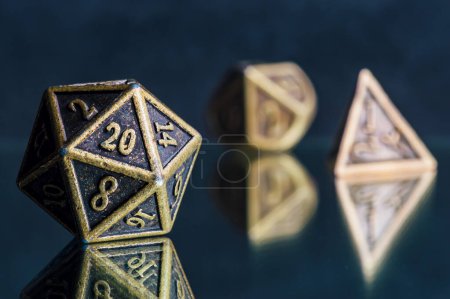 Close-up image of a metallic 20-sided Role-Playing dice on a reflective surface
