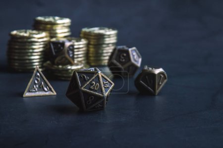 Close-up image of a set of metallic RPG dice and golden coins