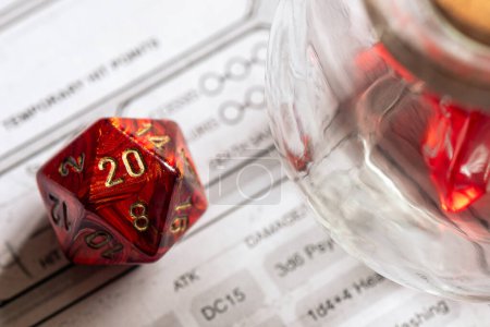 Red D20 dice alongside a glass jar on a character sheet, focusing on strategy and decision-making in role-playing games.