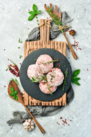 Photo for Raw burger patty. Caul-Fat Meatballs cutlet handmade. On a gray stone background. Top view. - Royalty Free Image