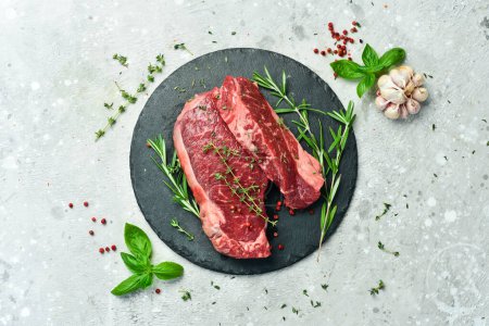 Photo for Meat. Aged striploin steak. On a gray concrete background. Free space for text. - Royalty Free Image