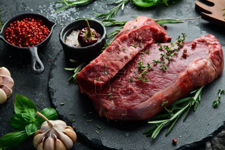 Photo for Aged juicy striploin steak. Meat. On a black stone background. Side view. - Royalty Free Image