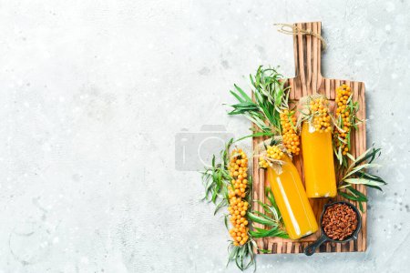 Photo for Fresh sprigs of sea buckthorn, honey and drink in a jar of sea buckthorn, viburnum and honey. On a concrete gray background. top view - Royalty Free Image