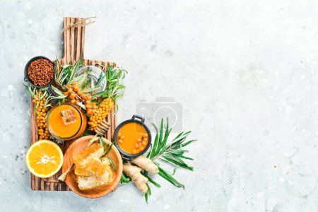 Photo for Jam from sea buckthorn and honey in a jar. On a concrete gray background. top view - Royalty Free Image