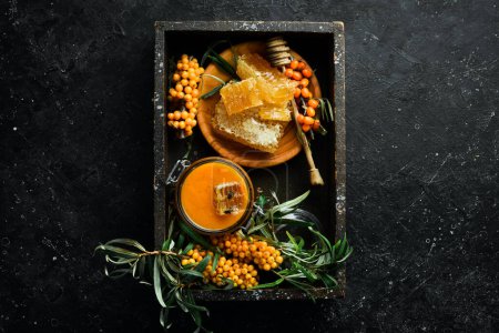 Photo for Autumn menu concept. Honey, sea buckthorn and citrus fruits. On a dark background. Top view. - Royalty Free Image